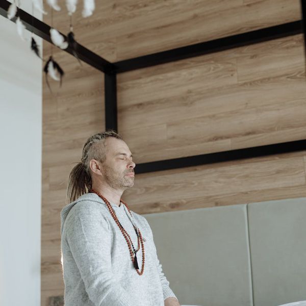 Man meditating after a workout session, embodying tranquility and focus.